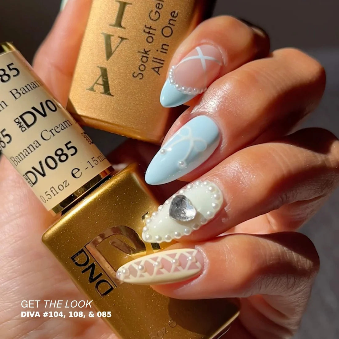 Hand pose showing DIVA 018 pastel blue gel manicure on natural nails with nail art