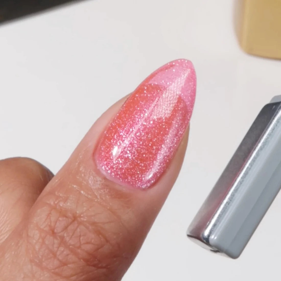Cat eye nail art using DIVA 9D Cat Eye Candy #13 Lollipop Pounce, highlighting the pink cat eye shimmer effect.