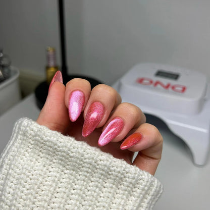 Hand manicure photo in DIVA 9D Cat Eye Candy #13 Lollipop Pounce, showing pink cat eye nail polish across all nails.