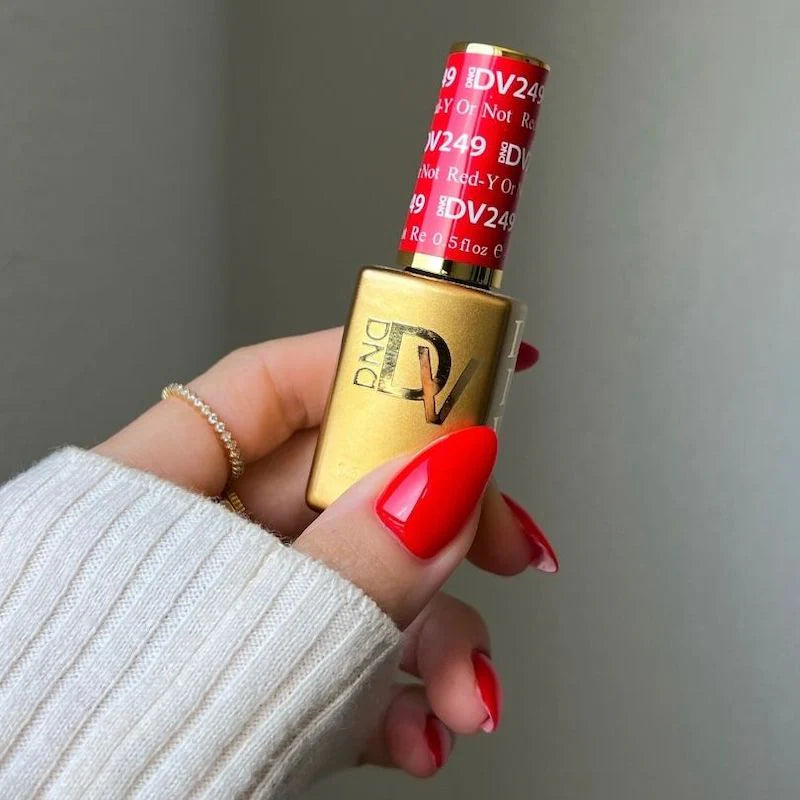 Manicured hand wearing diva red nail polish in Red-Y Or Not shade