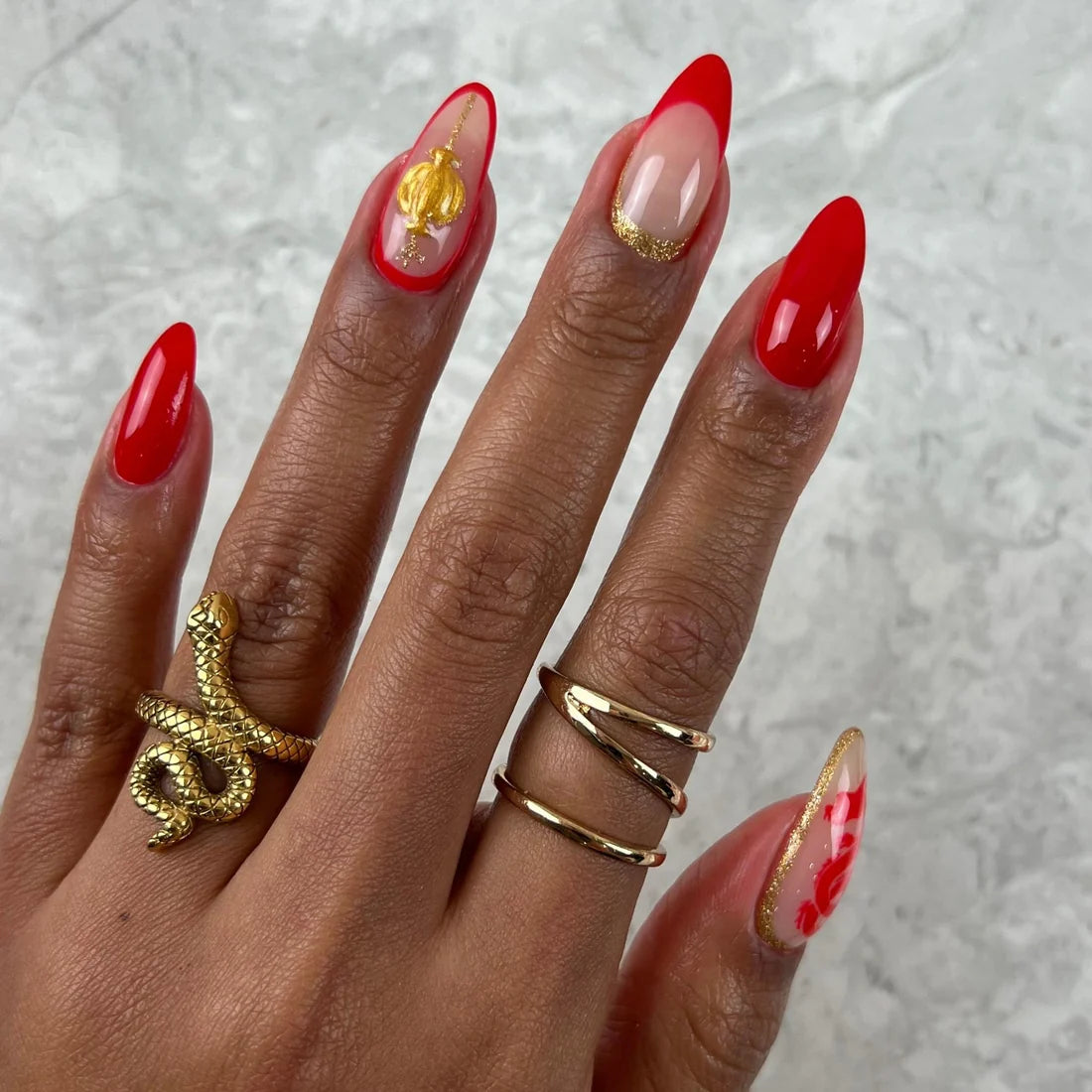 Thin gold gel art liner lines painted over a colour base for nail art
