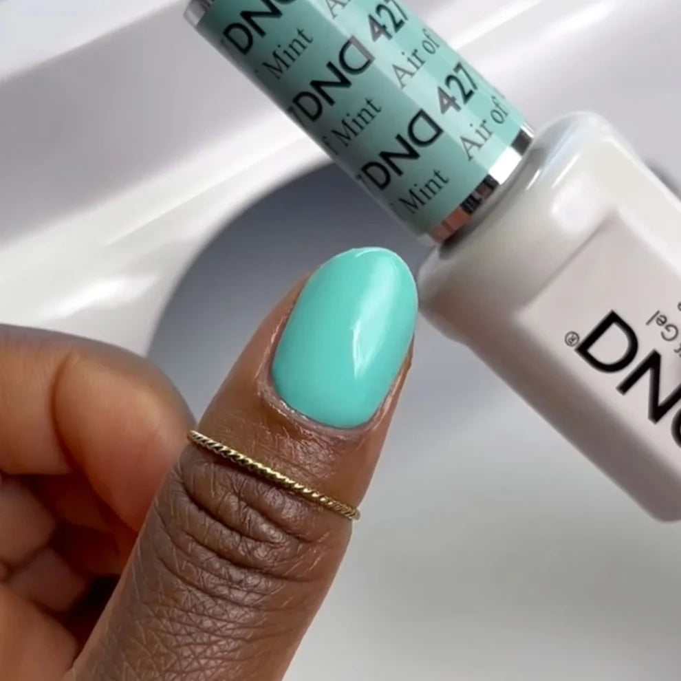 Close-up manicure showing DND Air Of Mint #427 mint green gel nail polish colour on nails.