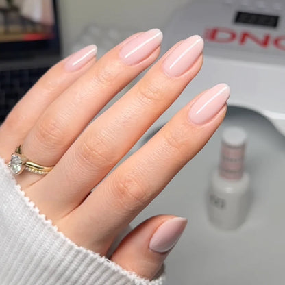 Sheer taupe DND Bare Neutral 2345 polish painted on natural nails highlighting the healthy flush underneath