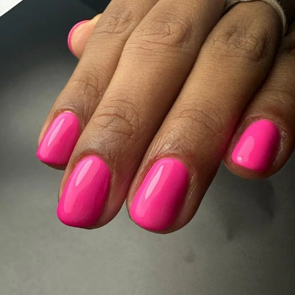 Close-up manicure showing DND Be My Valentine #499 rosy-toned pink gel nail polish colour on nails.
