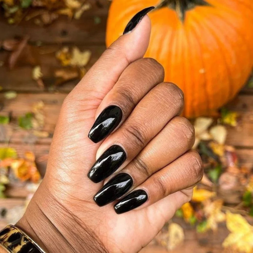 Close-up manicure showing DND Black Licorice #447 black gel nail polish colour on nails.