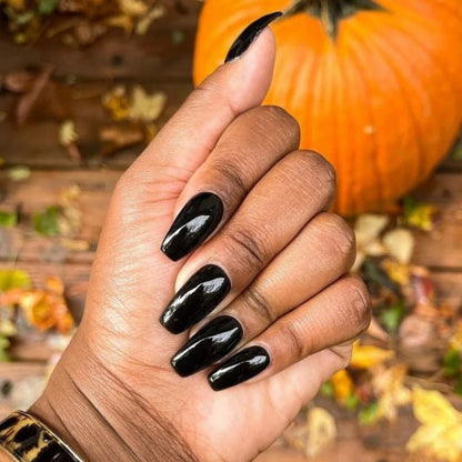 Close-up manicure showing DND Black Licorice #447 black gel nail polish colour on nails.