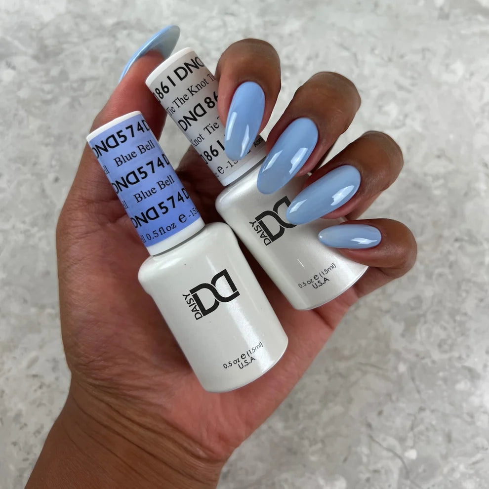 Close up manicure shot of DND Blue Bell #574 on the nail, highlighting the smooth finish and slate blue tone