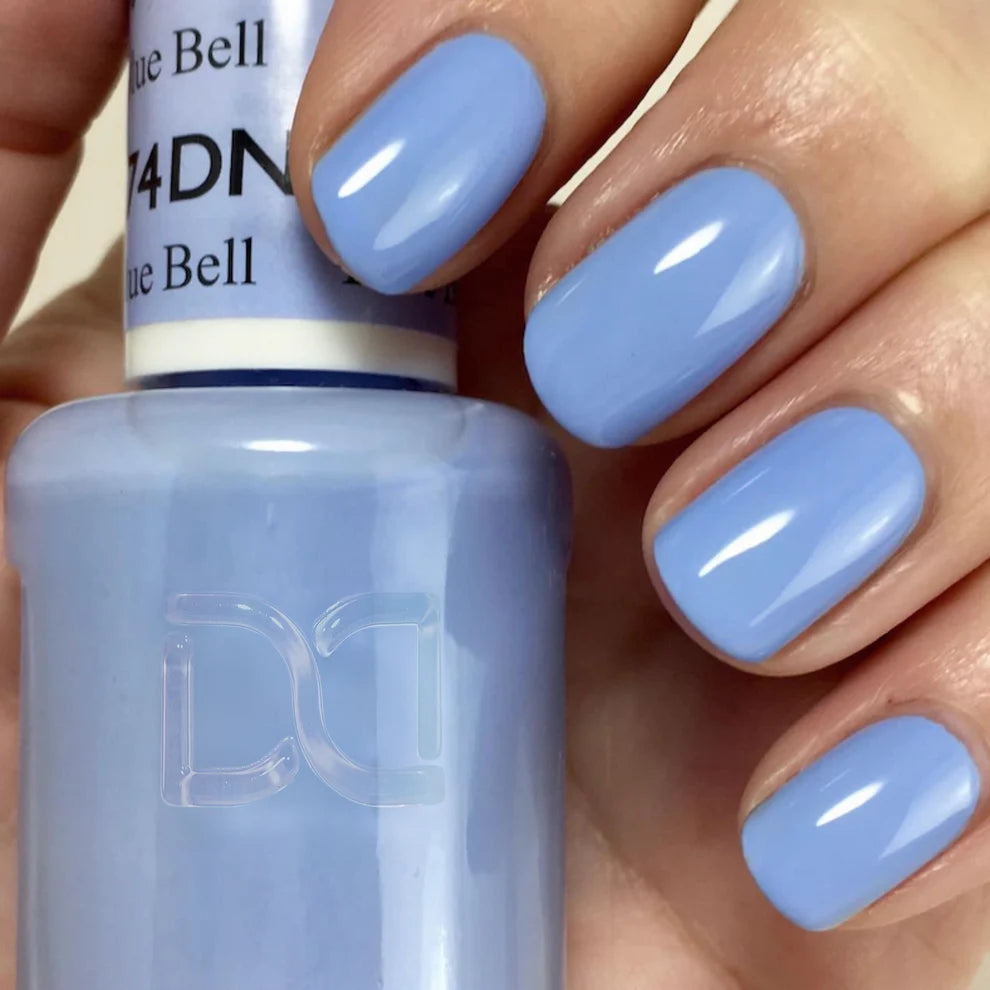 Hand wearing DND Blue Bell #574 gel polish, showing the trendy gray blue tone on the nails