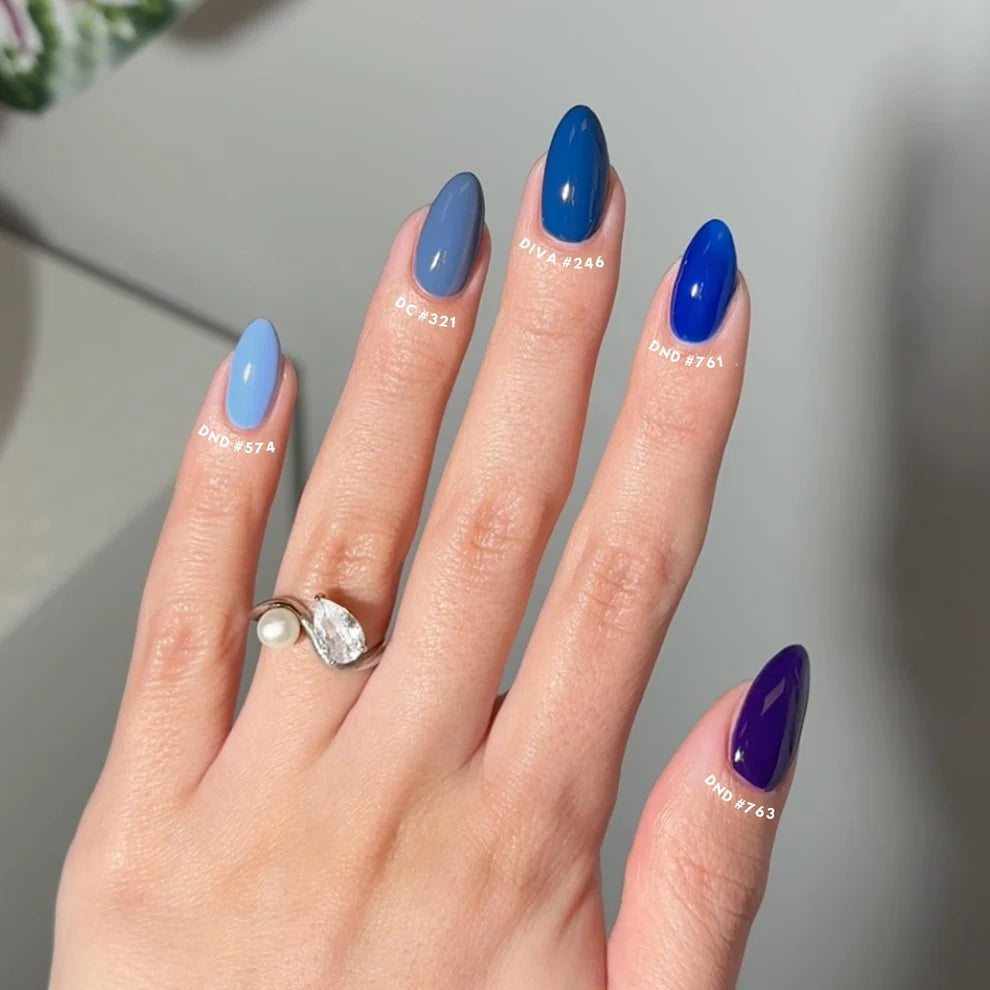 Finger nail painted with DND Blue Bell #574, a unique slate gray blue gel polish