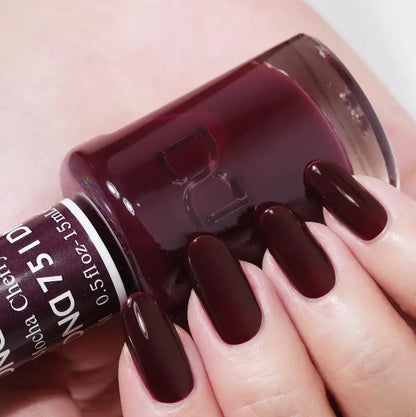 Hand manicure showing DND Cherry Mocha #751 gel polish applied to all nails in a glossy black cherry finish