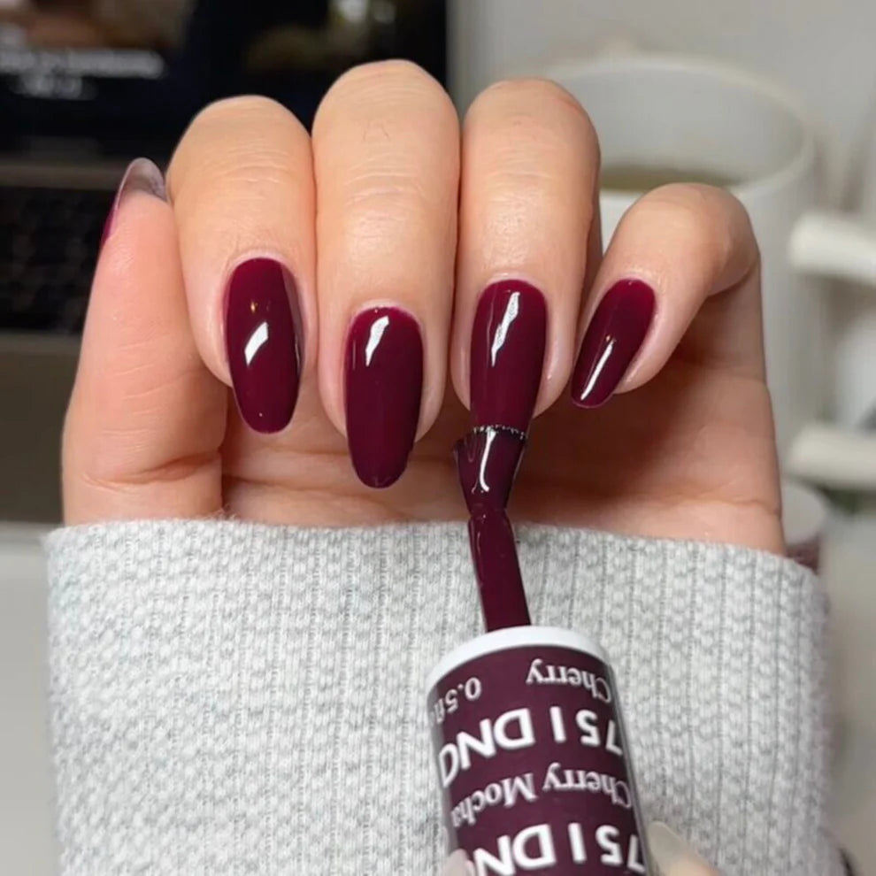 Full manicure showing DND Cherry Mocha 751 deep cherry brown gel polish applied on natural nails.