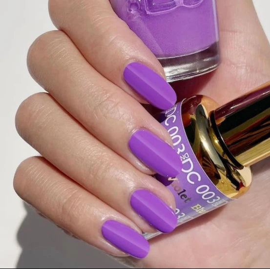 Manicured nails painted in DND DC Blue Violet #003 royal purple gel polish with blue undertones