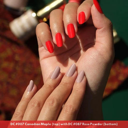 Manicured nails painted in DND DC Canadian Maple #007 red toned neon orange gel polish