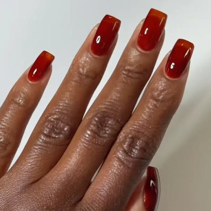 DND DC jelly gel polish on a dark skin tone hand for Amber 028 in a warm golden brown finish