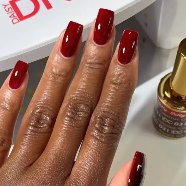 DND DC jelly gel polish on a dark skin tone hand for Cabernet 031 in a wine red finish