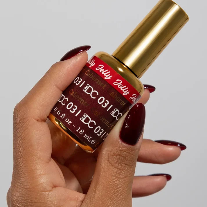 DND DC jelly gel polish on a manicured hand for Cabernet 031 showing the rich wine red glow in natural light