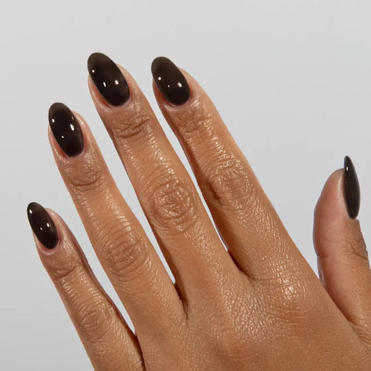 DND DC jelly gel polish on a manicured hand for Inky Black 036 showing the moody glossy finish in natural light