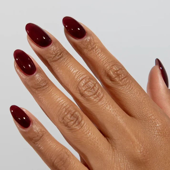 DND DC jelly gel polish on a manicured hand for Vineyard 032 showing the moody purple flush in natural light
