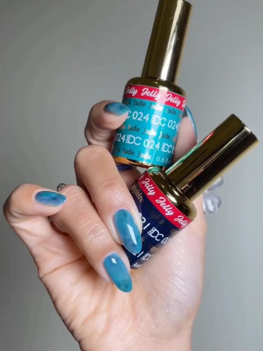 DND DC Ocean Glass Jelly gel polish swatch display featuring DC Jelly Jade and DC Jelly Sapphire 