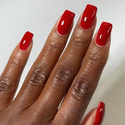 DND DC jelly gel polish on a dark skin tone hand for Sinner 029 in a ruby red finish