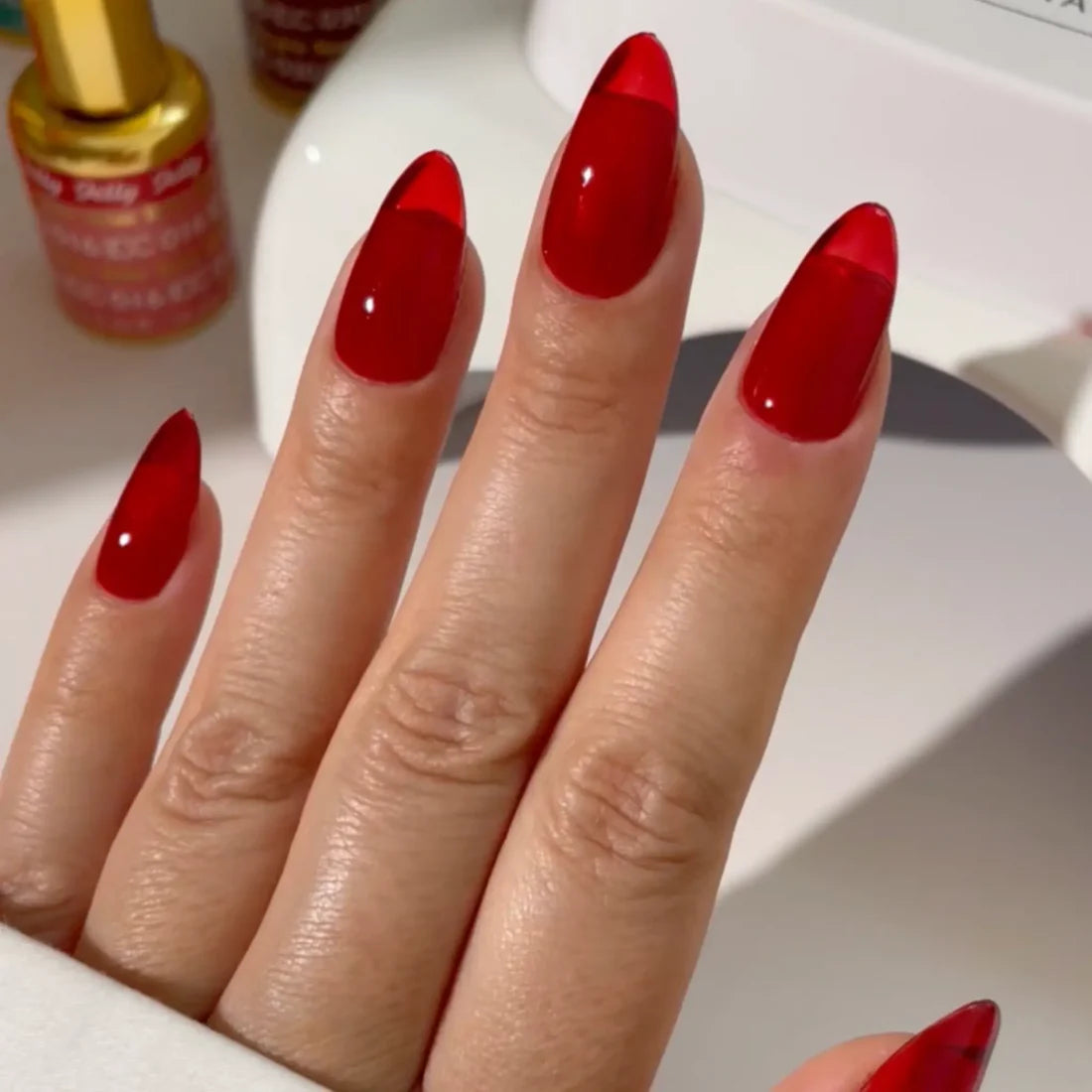 DND DC red jelly gel polish manicure application for Sinner 029 showing the finished salon style look
