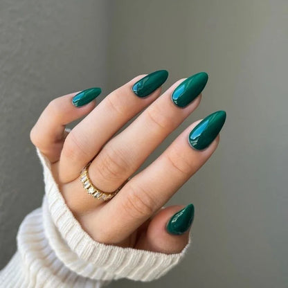 Hand pose showing DND DIVA 244 Emerald Meadow deep forest green gel manicure on natural nails