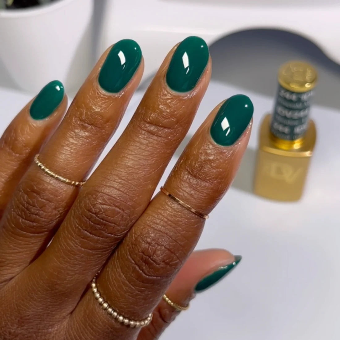 Close up manicure shot of DND DIVA 244 Emerald Meadow deep forest green gel nail polish