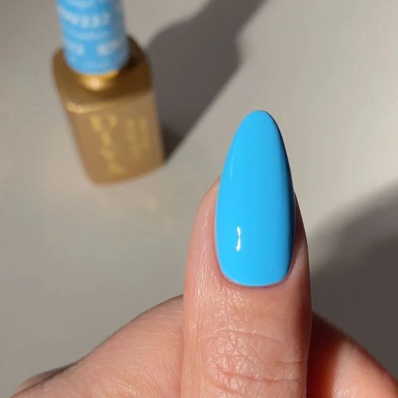 Deep sky blue gel manicure painted with DND DIVA Angel Numbers on natural finger nails