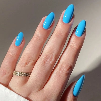 Hand showing finished manicure in DND DIVA Angel Numbers deep sky blue gel nail polish
