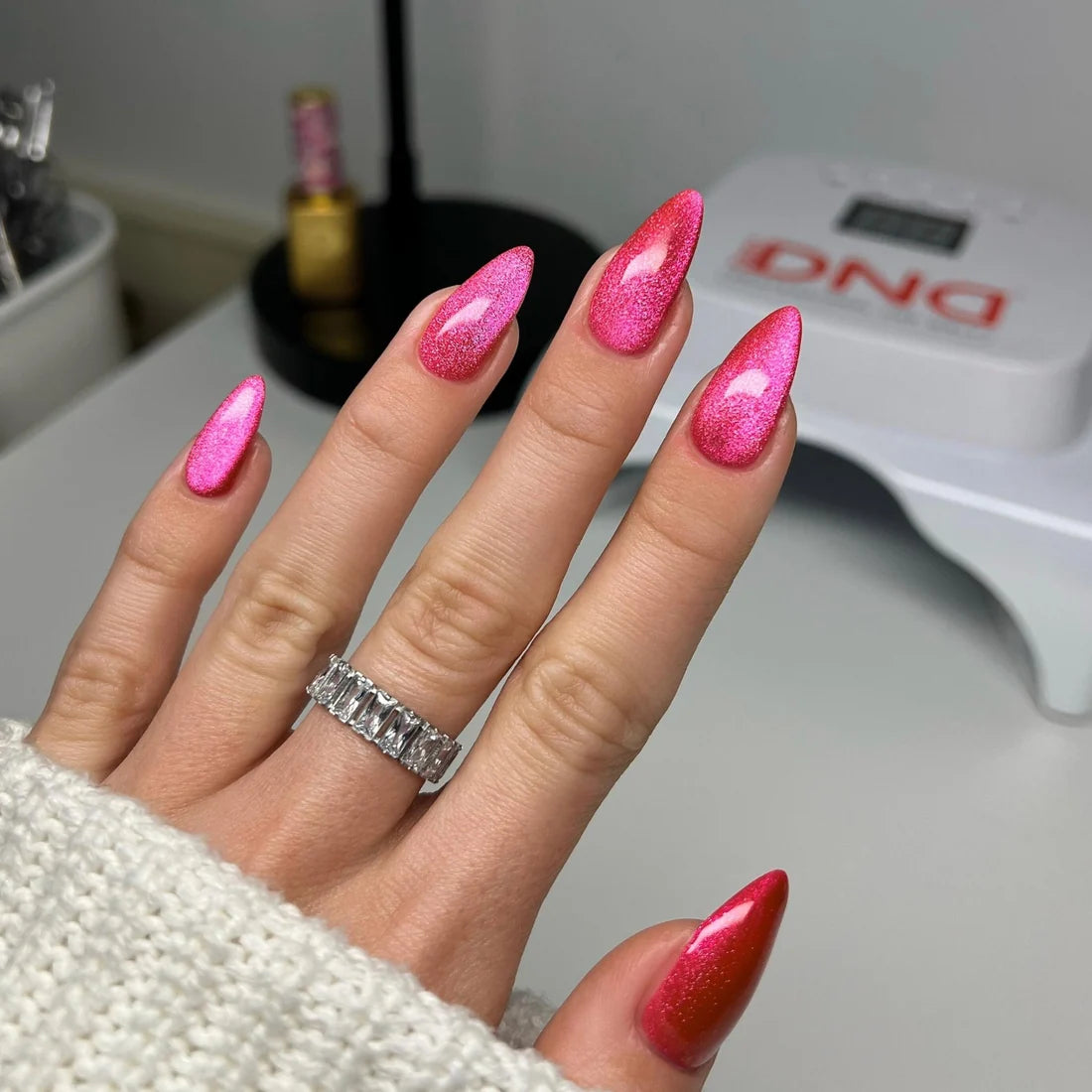 Full manicure in DND Diva Cat Eye Gel Polish #14 Hi Kitty, showing the hot pink cat eye finish on natural nails.