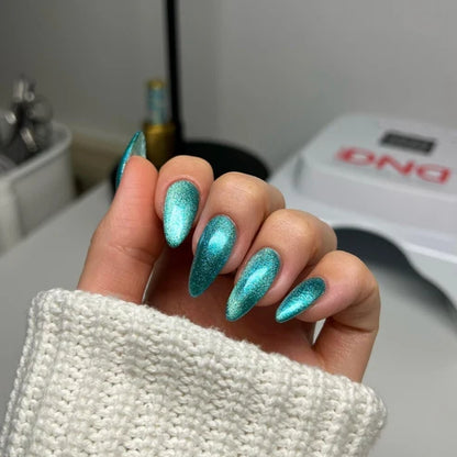 Cat eye nails done in DND Diva Cat Eye Gel Polish #16 Saltwater Tabby, highlighting the aquamarine shimmer effect.