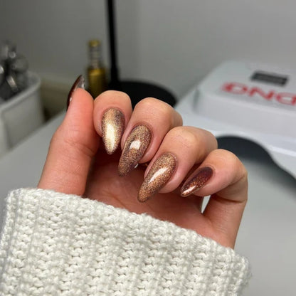 Cat eye nails done in DND Diva Cat Eye Gel Polish #18 Toffee Crisp, highlighting the brown sugar shimmer effect.