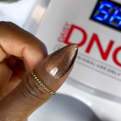 Close up swatch of DND Diva Cat Eye Gel Polish #18 Toffee Crisp showing the brown sugar cat eye nail polish effect.
