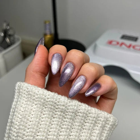 Cat eye nails done in DND Diva Cat Eye Gel Polish #19 Wild Berry, highlighting the muted grape shimmer effect.