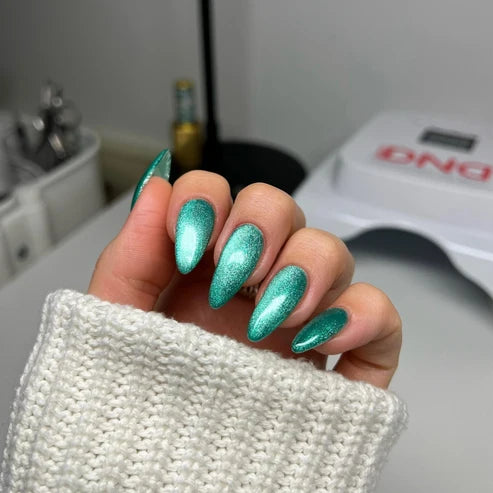 Cat eye nails done in DND Diva Cat Eye Gel Polish #20 Leopard Mint, highlighting the turquoise mint shimmer effect.