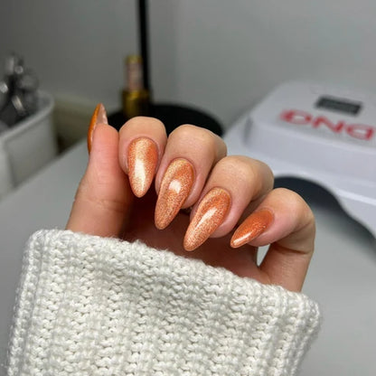 Cat eye nails done in DND Diva Cat Eye Gel Polish #21 Button Nose, highlighting the caramel orange shimmer effect.