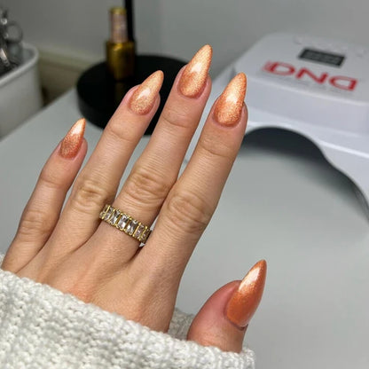 Full manicure in DND Diva Cat Eye Gel Polish #21 Button Nose, showing the caramel orange cat eye finish on natural nails.