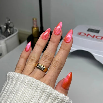 Full manicure in DND Diva Cat Eye Gel Polish #22 Jelly Belly Rubs, showing the watermelon pink cat eye finish on natural nails.