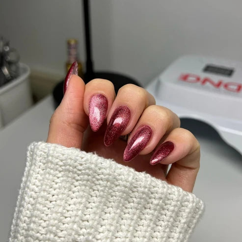 Cat eye nails done in DND Diva Cat Eye Gel Polish #24 Hot Cinnamon, highlighting the cinnamon pink shimmer effect.