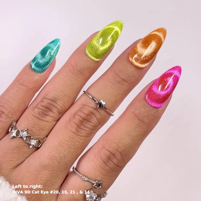 A close-up of a hand displaying four long, almond-shaped stiletto nails in vibrant, shimmering colors: teal, lime green, metallic gold, and hot pink. Each nail features a glossy cat-eye swirl pattern.