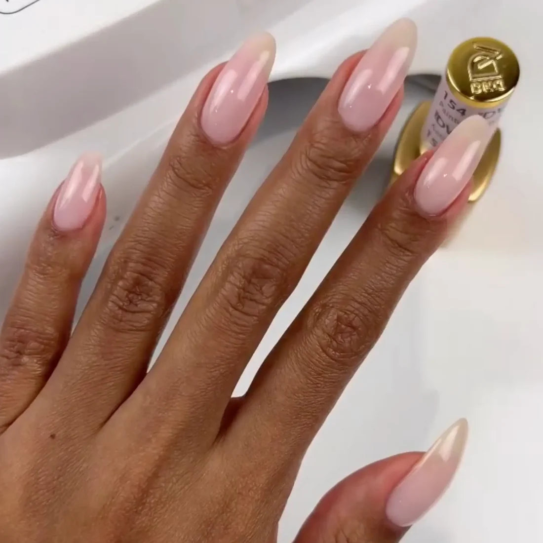 Light pink beige gel manicure painted with DND DIVA Painter's Antidote on natural nails with chrome powder