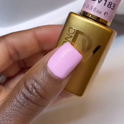 Hand showing finished manicure in DND DIVA Pink Ribbons bright neutral pink gel nail polish