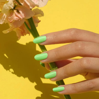 Close up manicure shot of DND Green Forest #568 on the nail, highlighting the bright neon finish and white undertone