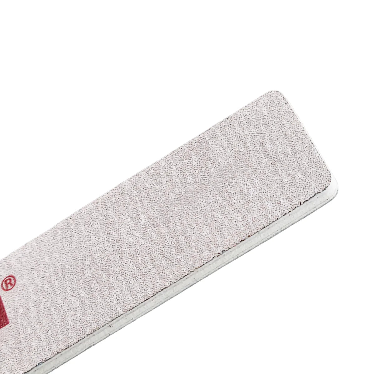 Close up of zebra coated 80 grit nail file texture used for acrylic and hard gel shaping

