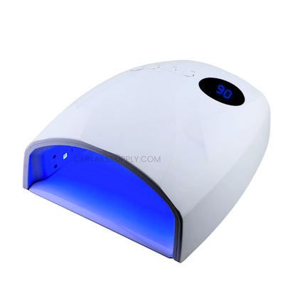 White UV/LED nail lamp with a blue illuminated interior and a digital temperature display showing 90 seconds, isolated on a white background.