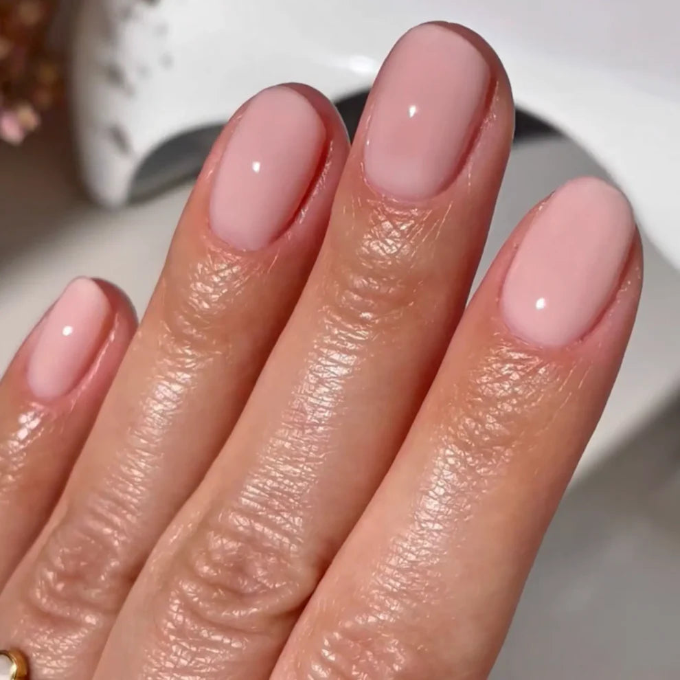 Close up manicure detail of DND Pink Bubble #8686 porcelain pink sheer gel polish finish