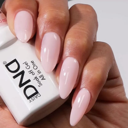 Close up manicured hand holding DND Pink Bubble #8686 gel polish bottle showing label and color