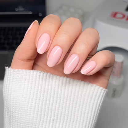 Front facing manicured hands showing DND Pink Bubble #8686 porcelain pink sheer nail polish finish
