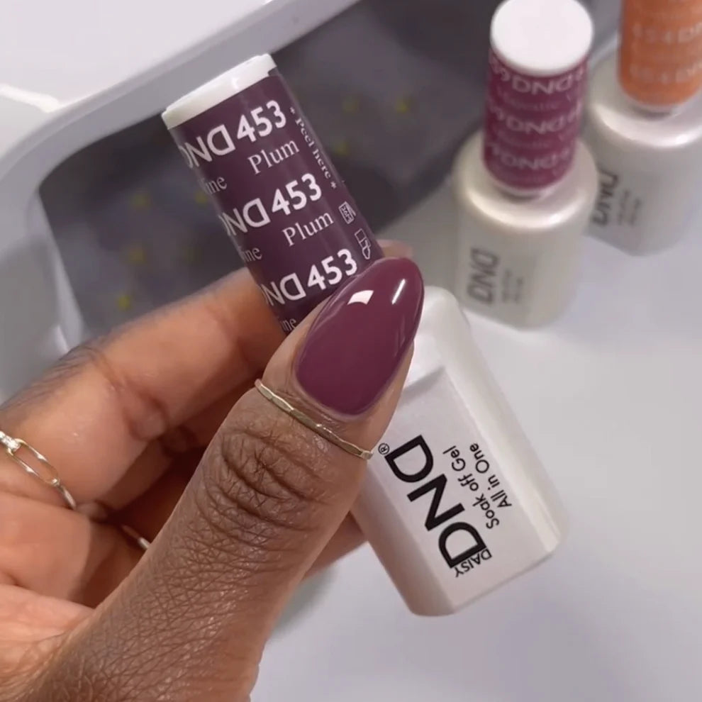 Close-up manicure showing DND Plum Wine #453 plum wine gel nail polish colour on nails.