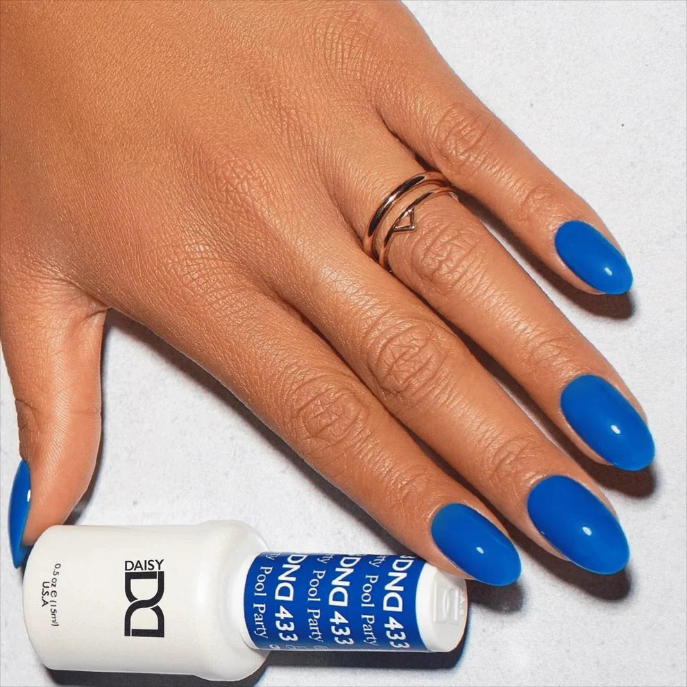 Pool blue manicure featuring DND Pool Party #433 while holding the matching Gel & Lacquer Duo.